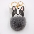 Detail of bulldog leather keychain with a fluffy grey pompom and gold lobster clasp - Gray