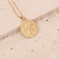 Detail of gold-tone irregular round medallion pendant with embossed portrait on stone - Gold Relief Portrait Coin (11#)