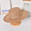 Detail of a beige wool felt fedora hat featuring a silk ribbon and bow on a wooden stand - Adult / Beige (Bow)