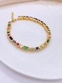Detail shot of golden bracelet with colorful geometric zircons on a white round plate - Bracelet