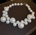 Elegant white multi-layer pearl necklace with vintage French style on leather background - White