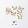 Macro view of 3D gold butterfly nail charm with zircons on a pink manicure display - Gold Full Rhinestone Butterfly Style (7191)