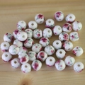 Macro view of round white ceramic beads with pink rose floral pattern for DIY jewelry - No.38-Pink Rose