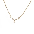 Macro shot of gold box chain and geometric constellation pendant with sparkling zircon - J-Libra