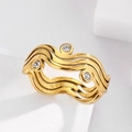 Macro shot of gold-plated stainless steel wavy ring with three inset clear crystals - Gold