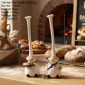 Set of two resin chef figurines with high hats holding bread and vegetables for kitchen decor - Small Set of 2
