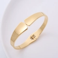 Bracciale dorato minimalista con cerniera a molla e finitura lucida 18 carati su ceramica - Oro