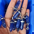 Handheld batch of blue crystal hexagonal pillar pendants with silver metal clasps - Watermelon Blue Glass