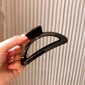 Minimalist black matte large shark hair claw clip in a sleek semi-circle hollow design - Oval Style