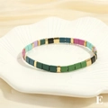 Detailed shot of multi-colored Tila beads with golden accents on a shell-textured plate - BR1670-E/Dark Green Blue Purple Mix