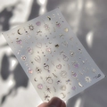 Detalle de pegatinas para uñas con estrellas doradas, lunas y corazones irisados - to4427-Luna Estrella Corazón-Circonio Rosa