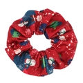 Detail shot of a red Christmas scrunchie featuring Santa, snowman, and candy cane prints - Red
