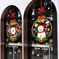 Christmas window decals set featuring cartoon Santa and Snowman wreaths on glass surface - Christmas Wreath 6128
