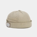 Detailed side view of a beige denim docker hat featuring a stylish vintage letter patch - Beige