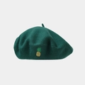 Close-up of dark green wool beret with detailed yellow pineapple embroidery detail - One Size / Green