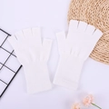 Close-up of white knitted fingerless gloves with ribbed cuffs on aesthetic background - One Size / White