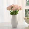 Handmade crochet pink rose flower with green leaves in a minimalist white ceramic vase - Beige