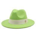 Close-up of wool fedora hat with beige ribbon and golden metallic circular logo detail - Fruit Green