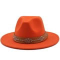 Close-up of bright orange wool fedora with brown studded leather belt and floral rivets - Orange