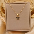 Macro shot of gold butterfly necklace with black zircon in a beige gift box on silk fabric - Gold + Black (Bead Chain)