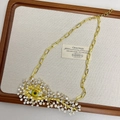 Close-up of golden evil eye necklace with green eye center and crystal teardrops - Gold Necklace B-42