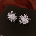 Macro detail of silver firework-shaped stud earrings on a reflective black display stand - 24# Silver Radial Firework (925 Sterling Silver Earring Post)