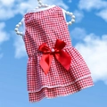 Detail of red plaid dog dress featuring a satin bow with pearl on a pearl hanger - Red Plaid Bow