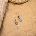 Close-up of bohemian leaf earrings with silver metal and amber teardrop resin stones - Antique Silver Amber Teardrop