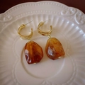 Detail of vintage C-shape gold earrings with amber resin drop on white ceramic plate - Coffee Irregular C-Shape