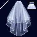Elegant white two-layer bridal veil with satin ribbon edge and secure hair comb detail - Bleached White