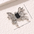 Macro view of silver butterfly charm with black gem and 2.5cm size markings - Gothic Rectangular Gem Butterfly Style