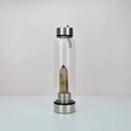 Glass water bottle featuring a natural hexagonal crystal prism and stainless steel base - Smoky Quartz Bottle