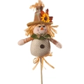 Detail of harvest scarecrow decor featuring a sunflower hat and wood support stick - Beige Outfit with Green Scarf