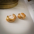 Detail of 14K gold plated C-shaped earrings with embossed B pattern on vintage book pages - 5# Golden B-Letter Embossed C-Shape Thick Hoop