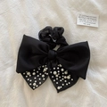 Large black bow hair claw clip with elegant pearl accents on a white fabric background - Black Pearl Bow Hair Ring