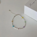 Detail of silver chain bracelet with colorful crystal beads and heart pendant on white background - Rainbow Bracelet (Gold Plated)