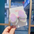 Detailed view of pink sequin bow hair clips on a white branding card for girls - Iridescent White