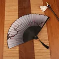 Classical Chinese folding fan with black frame, red plum blossoms, and silk tassel charm - Ink Plum