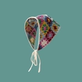 Detail of colorful hand-crocheted floral knit headscarf with retro grandmother square pattern - Vintage Granny Square Print