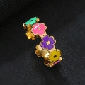 Macro detail of gold flower ring with colorful mint, purple, and yellow enamel petals - Four-Petal Flower