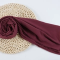 Burgundy chiffon hijab shawl with fine texture displayed on a straw mat background - 117