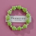 Minimalist light green ceramic beaded bracelet with star shapes on pink background - Tender Green Star Round (1586-11)