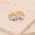 Floral enamel hoop earrings in gold with pink and blue flower patterns on beige stone - Pink