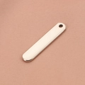 Polished silver stainless steel rectangular bar pendant on pink textured fabric - New Round Hole Steel Color (Aperture 2.5mm)