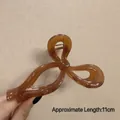 Elegant 11cm large amber resin hair claw clip in a stylish twisted bow design - Glossy Bow Brown-11cm