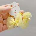 Pair of yellow tulle polka dot bow hair ties with pearl and gold ring decorations - Hair Ties (Pair) / Yellow