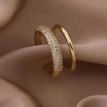 Macro shot of double-layer gold-plated ring with micro-pave zircons on champagne satin - Gold