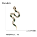 Golden snake brooch with sparkling rhinestones and measurements of 5.7cm by 2.5cm - Green