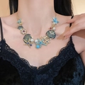 Detail of starfish and pearl pendant necklace with turquoise beads on a gold chain - 11# Necklace-Gold-Blue