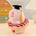 Pink Capybara plush doll wearing a black graduation cap with a donut accessory - Donut / Pink